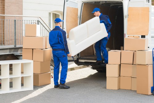 Man and van team loading boxes into a vehicle