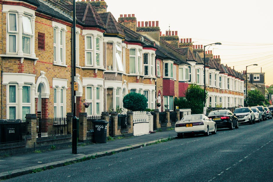 A brick residential building on the corner of Melbourne Terrace and Moore Park Road, London, with two white-framed windows on the upper floor and two doorways on the ground floor, one of which is part